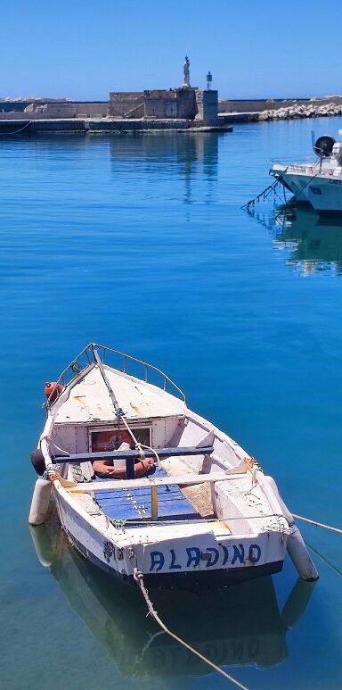 This fishing boat captures Sicily. Built on fishing, but now an empty boat tied to the quay.