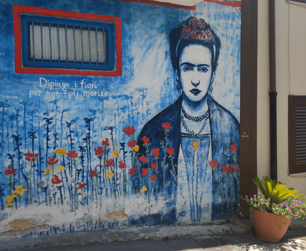 A wall mural in Borgo Parrini of Frida Kahlo entitled ' Frida to the Moon, by artist Peppe Vaccaro.