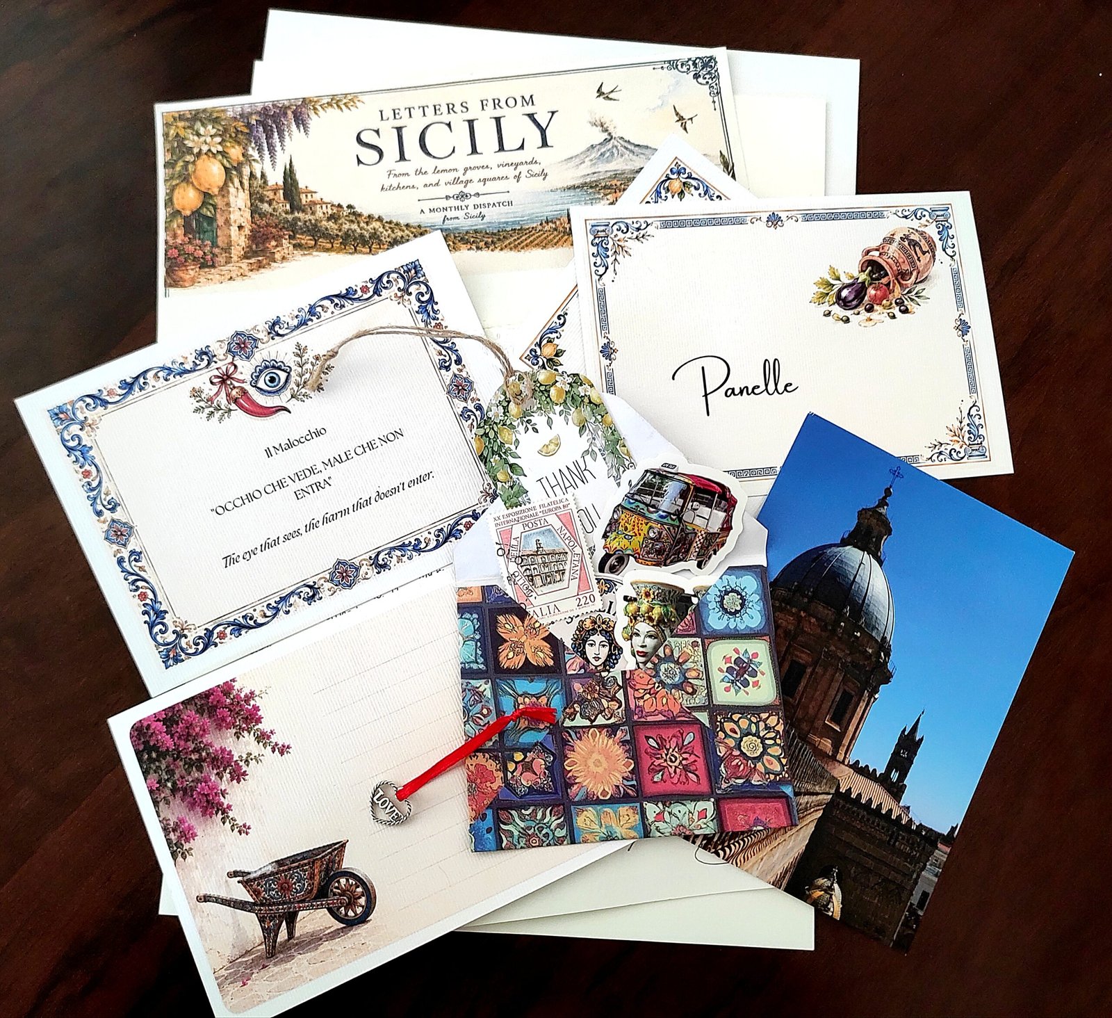 Contents lying on a wooden table for Letters from Sicily's Tier 2 snail mail club subscription. 