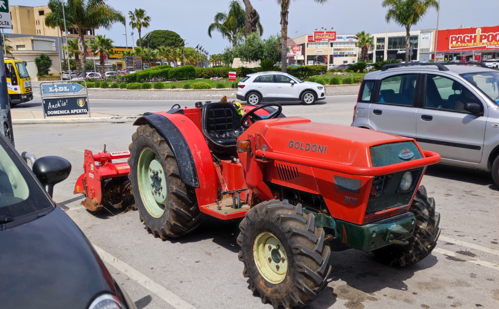 a tractor in a Lidl carpark in Sicily