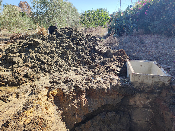 Hole dug to repair a burst provincial water pipe in Sicily