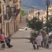 Men on a sidewalk in Sambuca di Sicilia sitting and doing sweet nothing - dolce far niente.